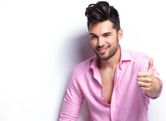 young fashion man shows thumb up