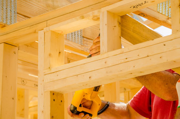 Building contractor worker using a reciprocating saw to cut