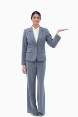Smiling businesswoman presenting with palm up