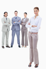 Fototapeta premium Secretary smiling and crossing her arms with happy business peop