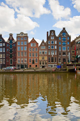 medieval houses over  canal water in Amsterdam