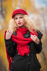 Attractive young woman with red cap in a autumn fashion shoot