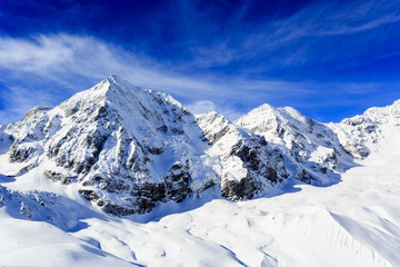 Fototapeta na wymiar Snow-capped peaks of the Italian Alps