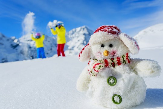Skiers with snowman enjoying winter