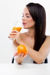  woman holding orange and orange juice