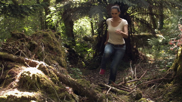 Casual young woman running in the woods