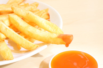 French fried dipped sauce on light table.