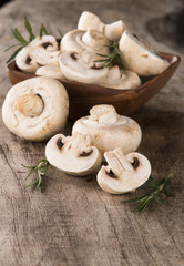 Fresh champignon mushrooms on wood
