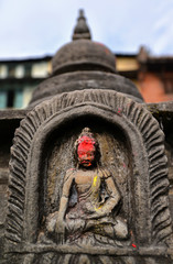 Bas relief statuette of sitting Buddha in Swayambhunath. Nepal