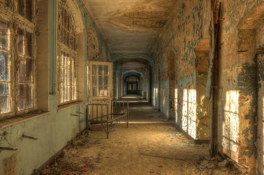 Abandoned hospital corridor with bed
