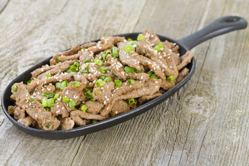 Bulgogi - Korean grilled marinated beef in a sizzle pan.