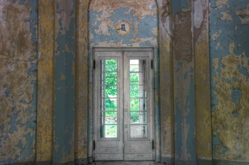 Old abandoned room with a clock over the door
