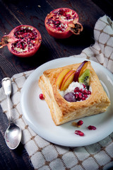 Delicious puff pastry with cream and fruits