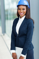 african female architect holding laptop computer