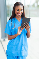 african doctor using tablet computer