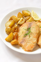 Fried fish fillet with baked potatoes