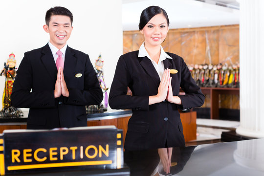 Chinese Asian Reception Team At Hotel Front Desk