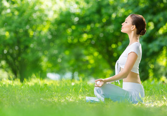 Profile of woman who sits in asana position zen gesturing