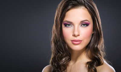 Portrait of beautiful woman with bright pink make-up 