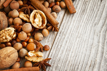 Nuts and Spices on Wooden Background