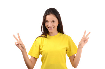 Happy girl with yellow t-shirt signing victory.