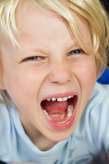 Close-up of an angry screaming child