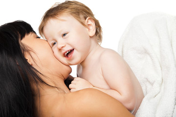 Mother with her baby after bathing in white towel