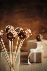 Chocolate Balls with golden Stars on the Wooden sticks, toned