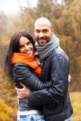 Fototapeta premium Happy middle-aged couple outdoors on beautiful autumn day