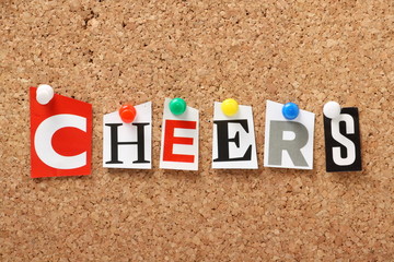 The word Cheers on a cork notice board