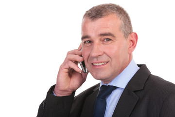 business man looks at you while on phone