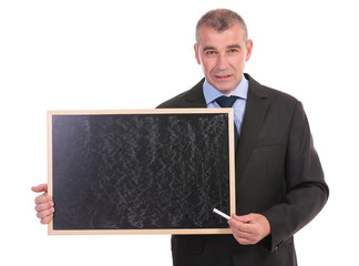 business man points with chalk on blackboard