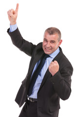 business man cheers while pointing upward