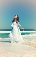 Fototapeta na wymiar beautiful pregnant woman standing on the beach. Photo in old ima