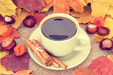 warming cup of coffee on autumn background