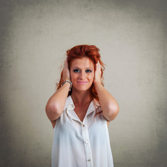 Deaf redhead woman portrait against grunge background.