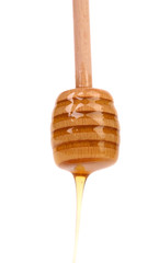 Honey on wooden dipper.