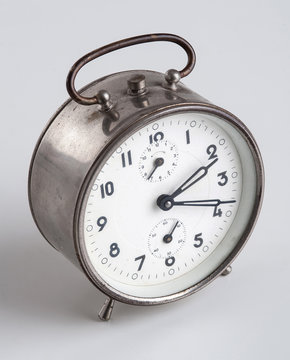 Old Alarm Clock isolated on white background.