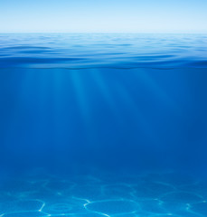 sea or ocean water surface with underwater split by waterline