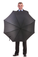 business man behind an opened umbrella