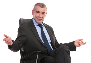 business man welcomes you from his chair