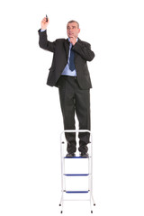 business man stands on ladder and writes