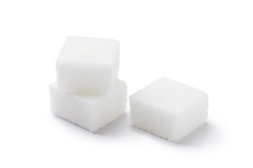 Cubes of sugar on white background
