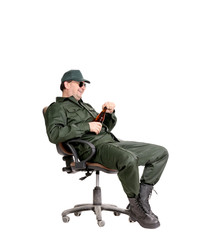 Man in workwear sitting with beer.