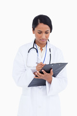 Fototapeta premium Close up of female physician taking notes