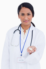 Fototapeta premium Close up of female physician holding pills in her palm