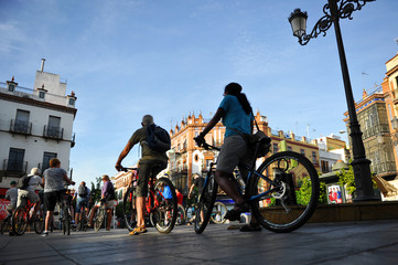 Tourists cycling in the city, Seville, Spain