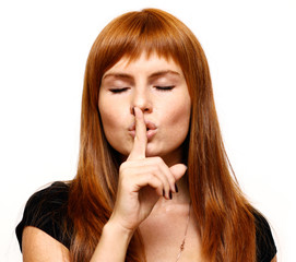 Naklejka premium Attractive teenage girl with finger on lips
