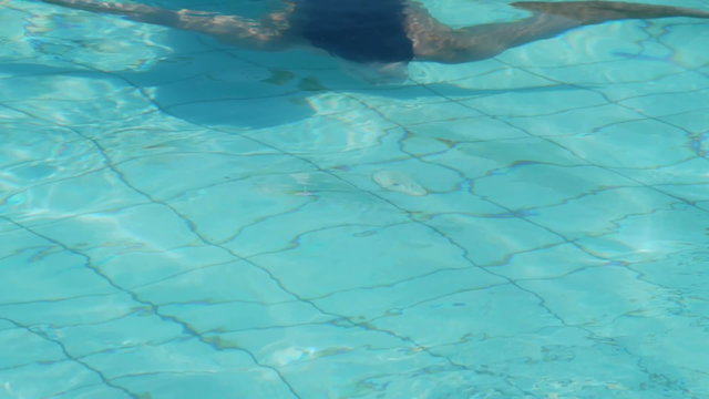 Young woman diving in a swimming pool