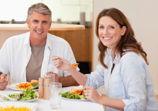 Smiling Couple Eating Dinner